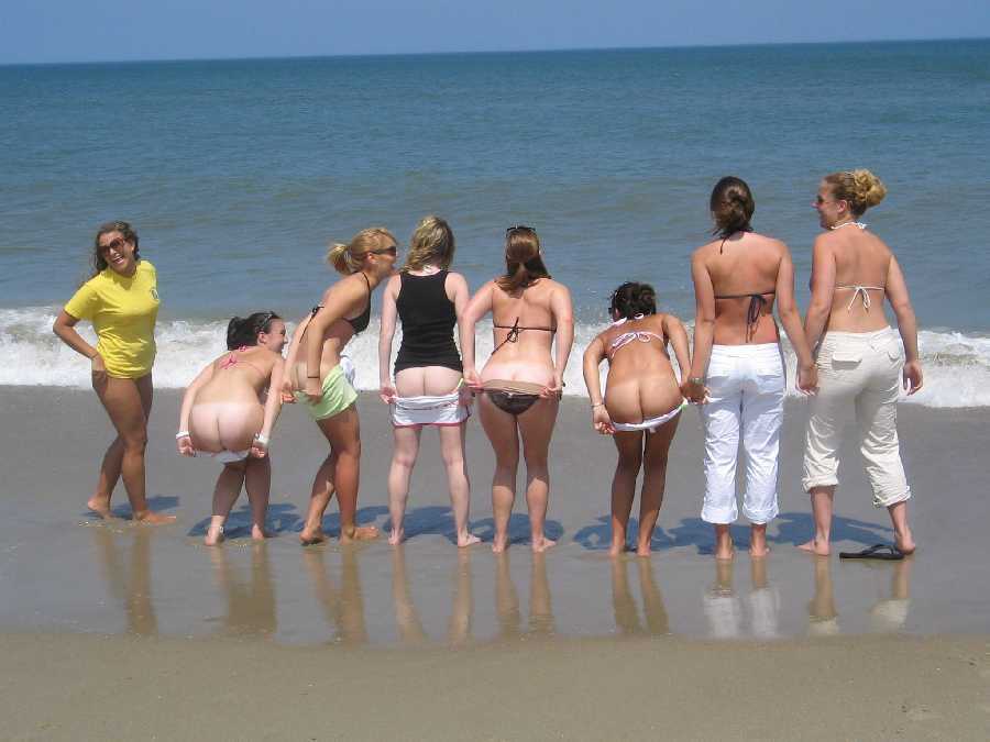 Nude ladies with pretty tits and hot asses relaxing on the beach