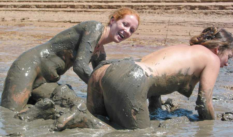 Nude girl covered in mud