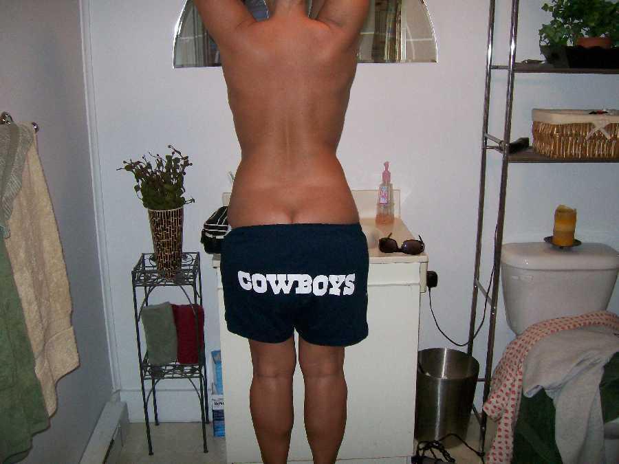 Naked Wife Pulling down her Cowboys Shorts